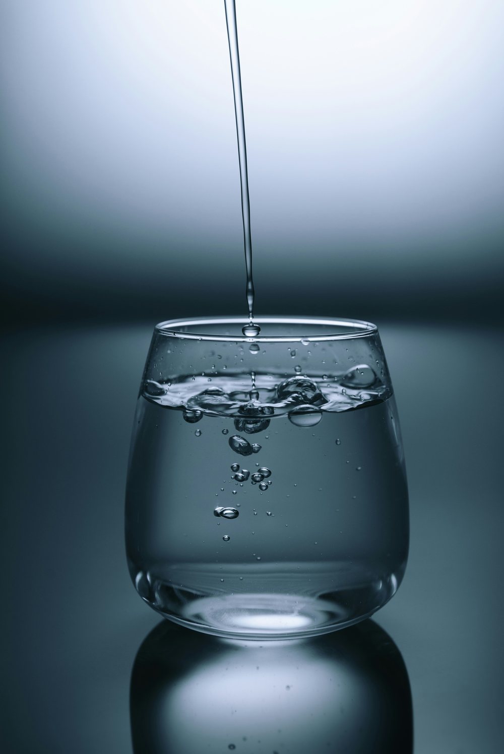 Pure, clean water pouring into glass - AquaZen Purity